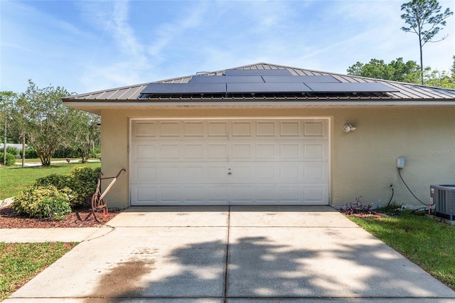 1601 NE 47th Ct, Ocala, FL 34470 - garage with central AC, solar panels, and driveway