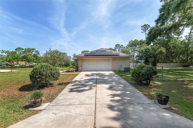 1601 NE 47th Ct, Ocala, FL 34470 - view of front facade featuring a front lawn, roof mounted solar panels, driveway, stucco siding, and central AC