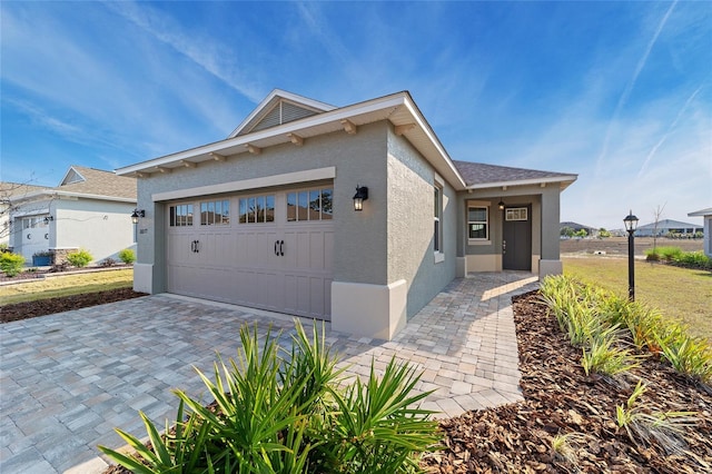 10277 SW 96th Loop, Ocala, FL 34481 - view of front facade featuring a garage, stucco siding, and decorative driveway