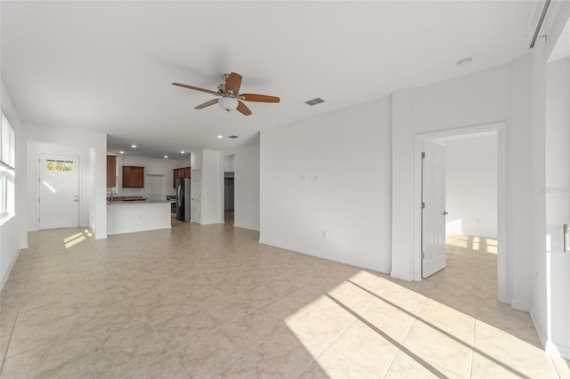 10277 SW 96th Loop, Ocala, FL 34481 - unfurnished living room with ceiling fan, recessed lighting, light tile patterned flooring, a sink, and baseboards