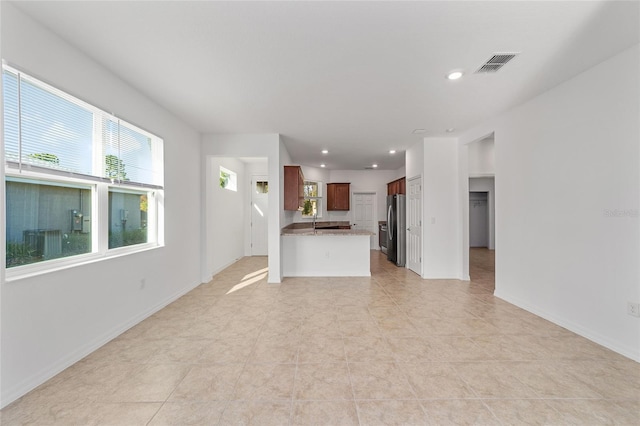 10277 SW 96th Loop, Ocala, FL 34481 - unfurnished living room with recessed lighting, light tile patterned floors, and baseboards