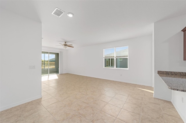10277 SW 96th Loop, Ocala, FL 34481 - empty room featuring ceiling fan, light tile patterned floors, and baseboards