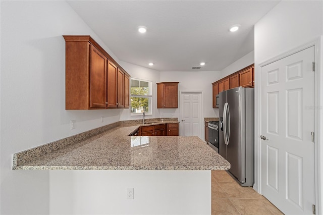 10277 SW 96th Loop, Ocala, FL 34481 - kitchen with appliances with stainless steel finishes, a sink, a peninsula, light stone countertops, and recessed lighting