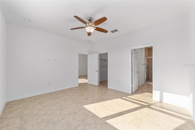 10277 SW 96th Loop, Ocala, FL 34481 - unfurnished bedroom with a walk in closet, ensuite bathroom, baseboards, and a closet