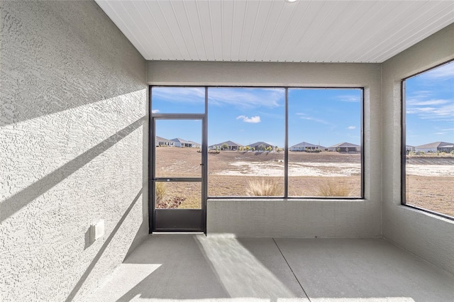 10277 SW 96th Loop, Ocala, FL 34481 - unfurnished sunroom with a residential view, healthy amount of natural light, and a textured wall