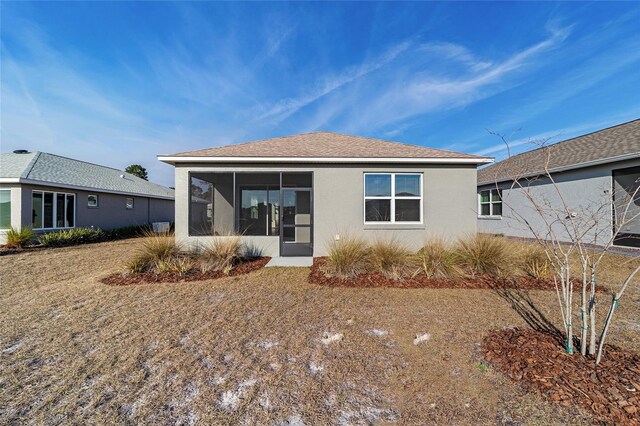 10277 SW 96th Loop, Ocala, FL 34481 - rear view of house featuring stucco siding and a sunroom