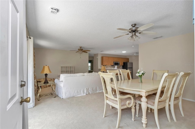 2608 Botello Ave, The Villages, FL 32162 - dining room with a ceiling fan, light colored carpet, and a textured ceiling