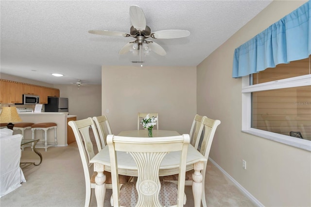 2608 Botello Ave, The Villages, FL 32162 - dining area with ceiling fan, light colored carpet, baseboards, and a textured ceiling