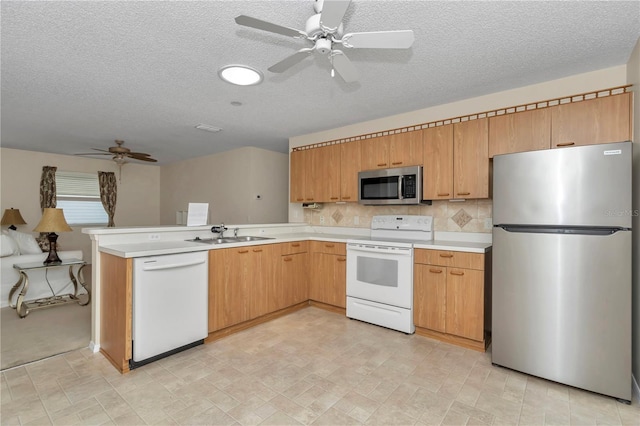 2608 Botello Ave, The Villages, FL 32162 - kitchen featuring stainless steel appliances, ceiling fan, a sink, a textured ceiling, and light countertops
