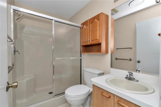 2608 Botello Ave, The Villages, FL 32162 - bathroom with a shower stall, toilet, vanity, and a textured ceiling