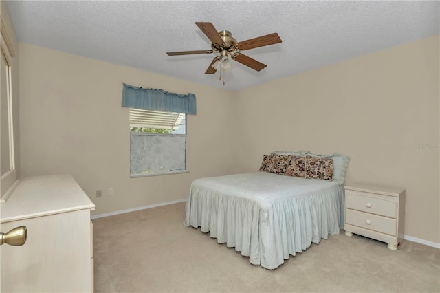 2608 Botello Ave, The Villages, FL 32162 - bedroom with light colored carpet, baseboards, ceiling fan, and a textured ceiling
