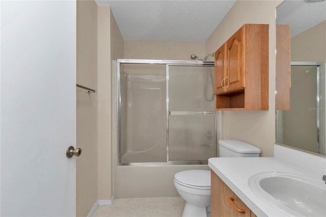 2608 Botello Ave, The Villages, FL 32162 - full bathroom with toilet, vanity, combined bath / shower with glass door, and a textured ceiling