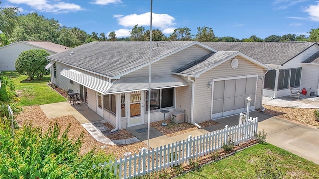 2608 Botello Ave, The Villages, FL 32162 - rear view of house with an attached garage, concrete driveway, and a shingled roof