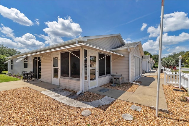 2608 Botello Ave, The Villages, FL 32162 - back of house featuring a sunroom and a patio