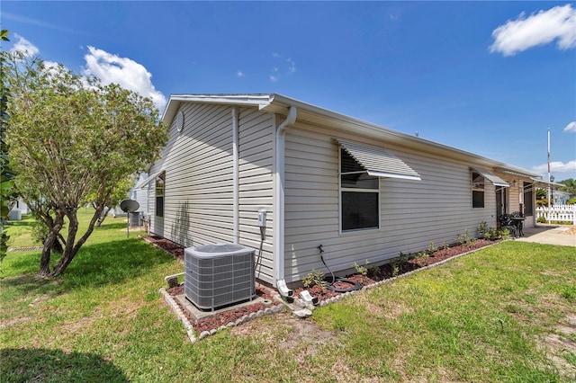 2608 Botello Ave, The Villages, FL 32162 - view of property exterior with cooling unit and a yard