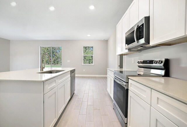 5141 SW 157th St, Ocala, FL 34473 - kitchen featuring stainless steel appliances, a sink, recessed lighting, baseboards, and light countertops