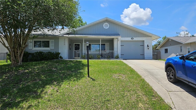 3776 N Honeylocust Dr, Beverly Hills, FL 34465 - ranch-style home with brick siding, an attached garage, concrete driveway, a front lawn, and covered porch
