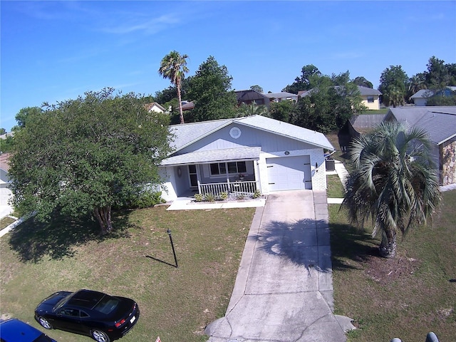 3776 N Honeylocust Dr, Beverly Hills, FL 34465 - view of front facade with covered porch, a garage, driveway, and a front lawn
