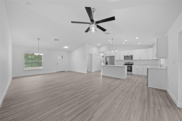 7 Walnut Pl, Ocala, FL 34480 - unfurnished living room featuring lofted ceiling, recessed lighting, a ceiling fan, a chandelier, and a sink