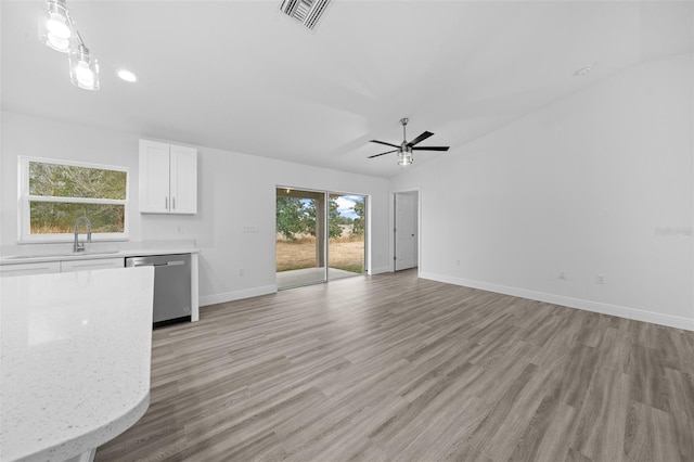 7 Walnut Pl, Ocala, FL 34480 - unfurnished living room with a sink, baseboards, a ceiling fan, and light wood finished floors