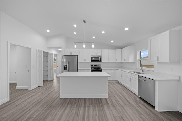 7 Walnut Pl, Ocala, FL 34480 - kitchen with appliances with stainless steel finishes, a sink, white cabinetry, a kitchen island, and recessed lighting