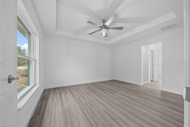 7 Walnut Pl, Ocala, FL 34480 - empty room with a raised ceiling, wood finished floors, and baseboards