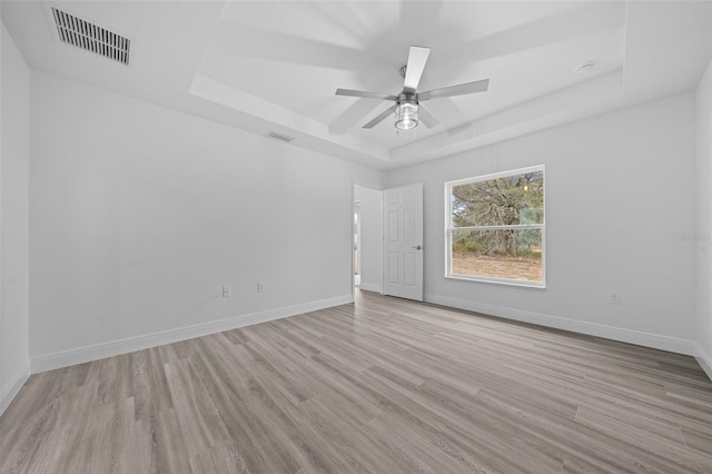 7 Walnut Pl, Ocala, FL 34480 - spare room with a raised ceiling, wood finished floors, ceiling fan, and baseboards