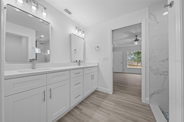 7 Walnut Pl, Ocala, FL 34480 - full bathroom featuring a ceiling fan, a marble finish shower, double vanity, wood finished floors, and baseboards