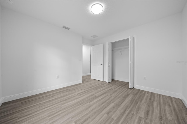 7 Walnut Pl, Ocala, FL 34480 - unfurnished bedroom featuring wood finished floors, baseboards, and a closet