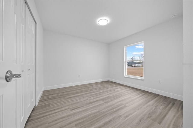 7 Walnut Pl, Ocala, FL 34480 - unfurnished bedroom featuring light wood-style flooring, a closet, and baseboards