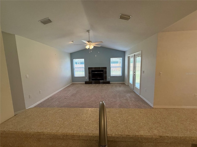 206 SE 8th Ave, Williston, FL 32696 - unfurnished living room featuring carpet flooring, lofted ceiling, ceiling fan, and a fireplace