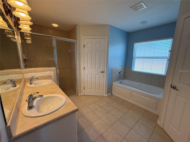 206 SE 8th Ave, Williston, FL 32696 - bathroom featuring tile patterned floors, a garden tub, a stall shower, and double vanity