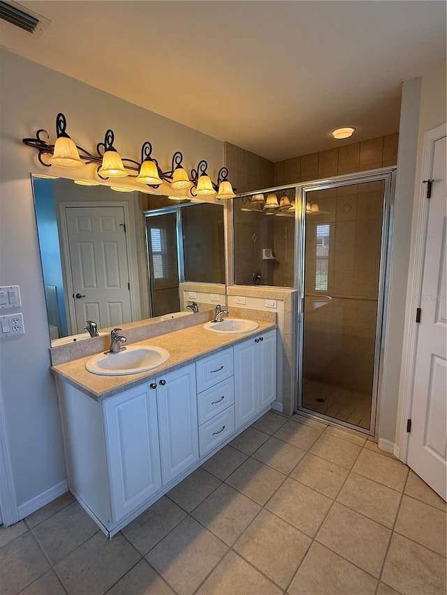 206 SE 8th Ave, Williston, FL 32696 - full bath with tile patterned flooring, double vanity, and a stall shower