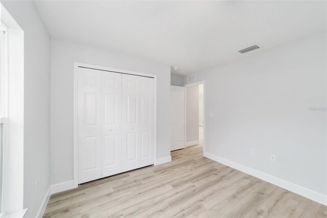 4386 SW 158th Ct, Ocala, FL 34481 - unfurnished bedroom featuring wood finished floors, baseboards, and a closet