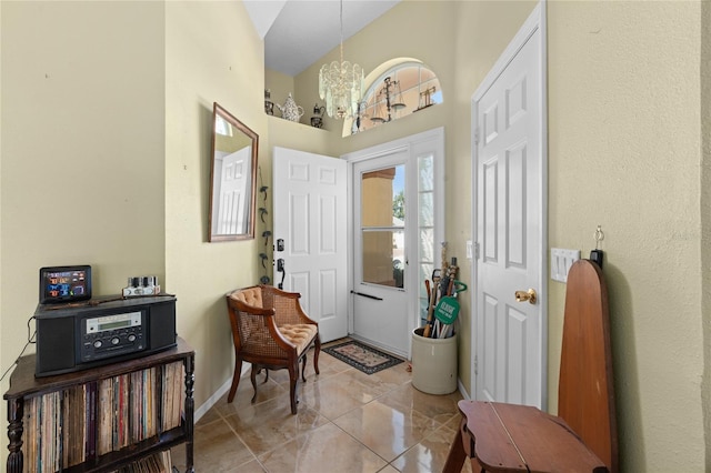 10468 S Drew Bryant Cir, Floral City, FL 34436 - foyer entrance with a chandelier, a towering ceiling, baseboards, and light tile patterned floors