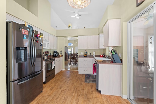 10468 S Drew Bryant Cir, Floral City, FL 34436 - kitchen with appliances with stainless steel finishes, ceiling fan, a sink, white cabinets, and light wood-style flooring