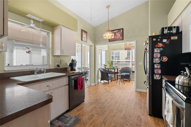 10468 S Drew Bryant Cir, Floral City, FL 34436 - kitchen with black dishwasher, dark countertops, range with electric stovetop, a sink, and light wood finished floors