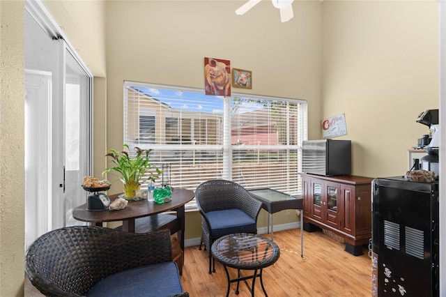 10468 S Drew Bryant Cir, Floral City, FL 34436 - sitting room featuring a high ceiling, light wood-type flooring, a ceiling fan, and baseboards