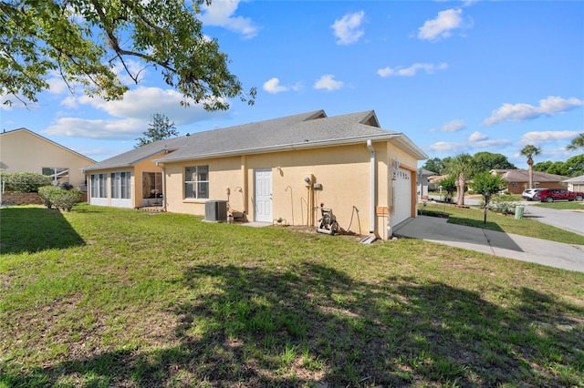 10468 S Drew Bryant Cir, Floral City, FL 34436 - rear view of property with a garage, driveway, a lawn, and central AC