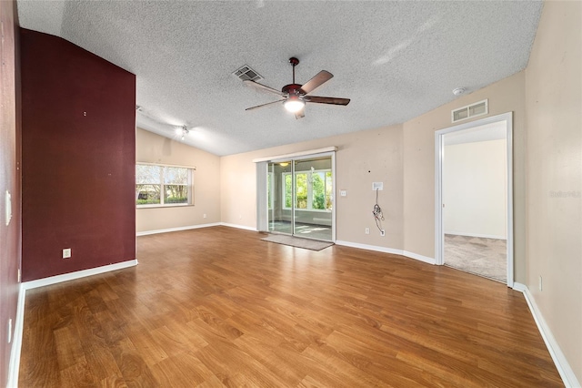 9001 SW 91st Cir, Ocala, FL 34481 - spare room featuring a ceiling fan, healthy amount of natural light, wood finished floors, a textured ceiling, and lofted ceiling
