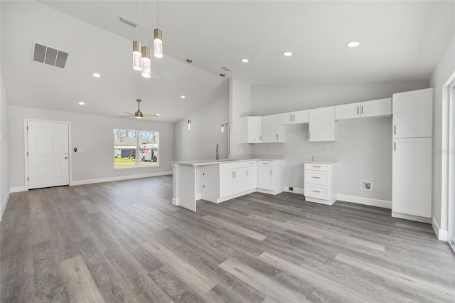 16697 SW 30 Avenue Rd, Ocala, FL 34473 - kitchen featuring open floor plan, white cabinets, baseboards, a sink, and light wood finished floors