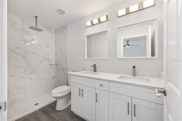 16697 SW 30 Avenue Rd, Ocala, FL 34473 - bathroom with double vanity, a marble finish shower, toilet, wood finished floors, and ceiling fan