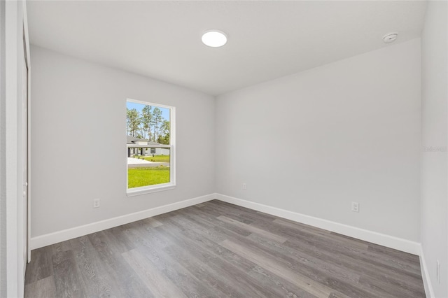 16697 SW 30 Avenue Rd, Ocala, FL 34473 - empty room with wood finished floors, baseboards, and a smoke detector