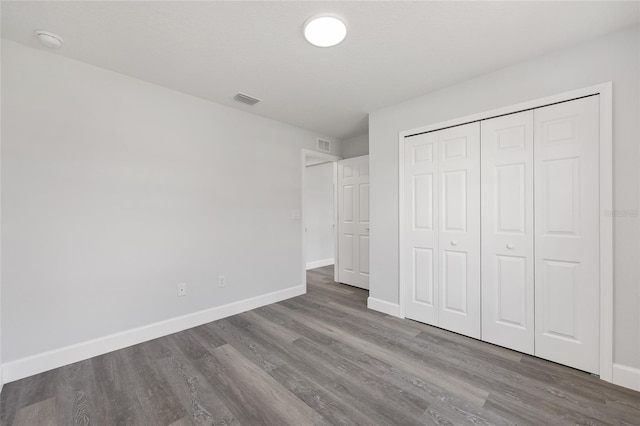 16697 SW 30 Avenue Rd, Ocala, FL 34473 - unfurnished bedroom featuring baseboards, wood finished floors, and a closet