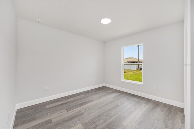 16697 SW 30 Avenue Rd, Ocala, FL 34473 - empty room with wood finished floors, baseboards, and a smoke detector