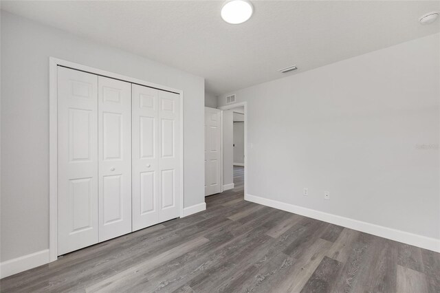 16697 SW 30 Avenue Rd, Ocala, FL 34473 - unfurnished bedroom with baseboards, wood finished floors, and a closet