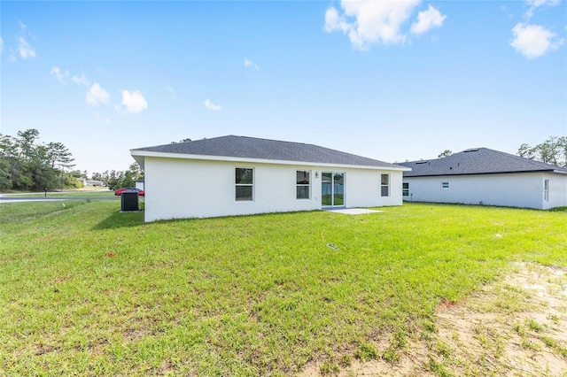 16697 SW 30 Avenue Rd, Ocala, FL 34473 - back of property featuring stucco siding, a yard, and central air condition unit