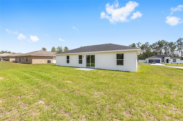 16697 SW 30 Avenue Rd, Ocala, FL 34473 - back of house featuring stucco siding and a yard