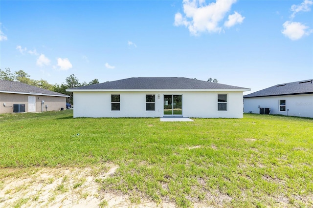 16697 SW 30 Avenue Rd, Ocala, FL 34473 - back of house with central AC, stucco siding, and a lawn