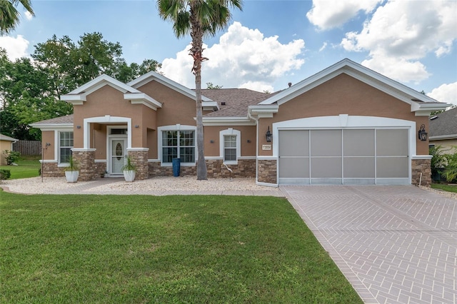 12804 SE 90th Court Rd, Summerfield, FL 34491 - view of front of property with stucco siding, stone siding, driveway, a front lawn, and a garage